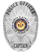 a silver police badge with a star