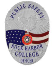 police badge Rock Harbor College Officer silver badge a close up of a badge