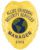 A striking visual of a custom metal badge in gold color, highlighting its ornate design and prominent globe emblem, featuring the words “Allied Universal Security Services” and a reliable safety pin attachment for optimal security.
