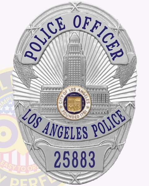 Los Angeles police custom silver metal badge showing a reflective silver shield with a detailed city hall emblem, blue text POLICE OFFICER on an arched upper banner and LOS ANGELES POLICE on the middle banner, finished with a blue numbered plate 25883 at the base and safety pin attachment.