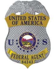 Federal Agent silver badge with blue text and state of Montana center seal a close-up of a badge