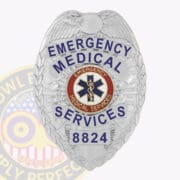 A shiny silver EMS badge featuring an eagle emblem at the top. The badge prominently displays the words 'EMERGENCY MEDICAL SERVICES' in bold blue letters. At the center, a circular emblem features the caduceus symbol, surrounded by a red border with the words 'EMERGENCY MEDICAL SERVICES.' The badge number '8824' is located at the bottom, emphasizing its official status. This badge exemplifies quality and professionalism, making it an ideal representation of EMS Badge EMT Badge and emergency medical technician badges.