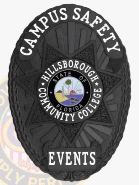 A polished custom metal badge in black color equipped with a safety pin attachment, featuring "CAMPUS SAFETY" prominently at the top. The badge displays a central emblem for Hillsborough Community College, along with the word "EVENTS," ensuring clear identification for event security personnel.