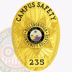 This custom metal badge in gold color with a safety pin attachment showcases the words "campus safety" in bold lettering. The intricate star design includes the hillsborough community college logo and the state emblem, making it ideal for campus security personnel.
