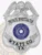 A sleek custom metal badge in silver color with a safety pin attachment, prominently featuring "PRIVATE INVESTIGATOR." The badge showcases an eagle emblem and the Texas state seal, reflecting its professional design and significance for investigators.