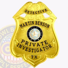A polished custom metal badge in gold color with a safety pin attachment, prominently displaying "detective martin benson. " the badge features the texas state seal and "private investigator" in bold lettering, highlighting its significance and authority for investigative roles.