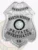 A detailed image of a custom metal badge in silver color with a safety pin attachment, highlighting "PRIVATE INVESTIGATOR" and the Texas state seal. This badge’s polished design reflects its importance as a distinguished accessory for investigators.