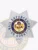 An engaging representation of a custom metal badge in silver color, exhibiting an elegant design with the name “State of Arkansas” in the center and the title “Bail Enforcement US Agent,” designed with a safety pin attachment for effortless integration into attire.