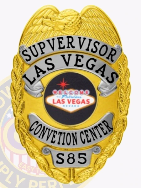 An eye-catching custom metal badge in gold color with silver accents, adorned with "SUPERVISOR LAS VEGAS" prominently displayed above a round emblem that welcomes guests to Las Vegas. The badge features the unique identification number S85 and comes with a safety pin attachment for secure placement.