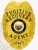 A polished visual of a custom metal badge in gold color, exhibiting an elegant design with the name “State of Arizona” and the title “Fugitive Recovery Agent,” designed with a practical safety pin attachment for dependable use on clothing.