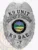 An eye-catching custom metal badge in silver color, designed as a shield with "K9 UNIT" and "DEPARTMENT OF CORRECTIONS" prominently displayed at the top. The central design illustrates the state seal of Ohio, complemented by "K9 BAE" and "#7," equipped with a safety pin attachment for secure wear.