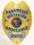 A polished custom metal badge in gold color displaying the full title and emblem for emergency services with eye-catching silver panels, designed for easy display with a safety pin attachment for reliable use.