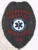 A distinctive custom metal badge in black color with a safety pin attachment designed for emergency medical services personnel. The badge prominently features "EMERGENCY MEDICAL SERVICES," alongside the star of life and "CA," showcasing dedication to providing critical care and support during emergencies.