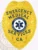A polished custom metal badge in gold color equipped with a safety pin attachment, featuring "EMERGENCY MEDICAL SERVICES" prominently at the top. The badge displays a central emblem representing emergency medical technicians, ensuring clear identification for first responders.