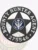 An artistic portrayal of a custom metal badge in black color with a safety pin attachment, prominently featuring "BOUNTY HUNTER AGENT." The badge incorporates intricate details, including the eagle and star, illustrating its essential role for bounty hunters.