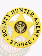 An elegant custom metal badge in gold color with a safety pin attachment, featuring the text "BOUNTY HUNTER AGENT" around a central eagle motif. The badge represents integrity and service in the field of bounty hunting.