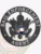 A detailed image of a custom metal badge in black color with a safety pin attachment, highlighting "BAIL ENFORCEMENT AGENT." This badge’s refined design showcases its importance as a distinguished accessory for professionals in the bail enforcement industry.