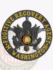 A captivating visual of a custom metal badge in black color, emphasizing detailed engravings of an eagle and the phrase “Fugitive Recovery Agent” in yellow, featuring a sturdy safety pin attachment for dependable use on uniforms.
