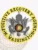A polished custom metal badge in gold color with a safety pin attachment, prominently displaying "FUGITIVE RECOVERY AGENT" and "WASHINGTON." The badge features a detailed eagle emblem and the Alabama state seal, symbolizing authority and professionalism in fugitive recovery.