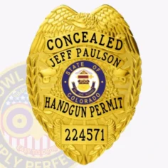 Highlighted is a custom metal badge in an eye-catching gold finish, featuring the state of colorado emblem and the inscription "handgun permit. " the reliable safety pin attachment makes this badge ideal for those who require a stylish and functional identification solution.