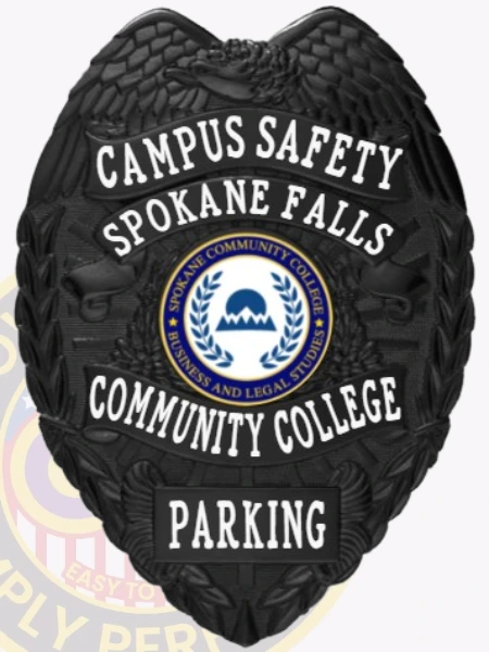 This custom metal badge in black color with a safety pin attachment showcases the text "CAMPUS SAFETY" and "SPOKANE FALLS" in striking white lettering. The central design includes the Spokane Community College logo, enhancing its visibility and authority for campus security.