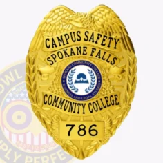 A unique custom metal badge in gold color with a safety pin attachment designed for spokane community college. The badge prominently displays "campus safety spokane falls" at the top, with a central emblem and the number "786," symbolizing authority and commitment to campus security.