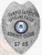 A sleek custom metal badge in silver color with a safety pin attachment, prominently displaying "CAMPUS SAFETY SPOKANE FALLS" at the top. The badge features a central emblem for Spokane Community College, highlighting its focus on business and legal studies, with the identifier "S7-85" at the bottom for clear identification.