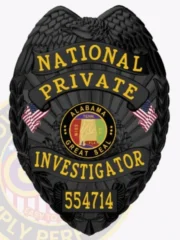 A striking custom metal badge in black color with a safety pin attachment, prominently featuring "NATIONAL PRIVATE INVESTIGATOR" in bold yellow lettering. The badge includes the Alabama state seal and small flags, emphasizing its professional design and authority.