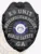 This striking custom metal badge in black color showcases a detailed shield design with "K9 UNIT" and "METROPOLITAN POLICE" inscribed at the top. The central emblem highlights the state seal of Georgia, complemented by "PUBLIC SAFETY" and "GA," and features a safety pin attachment for practical wear.