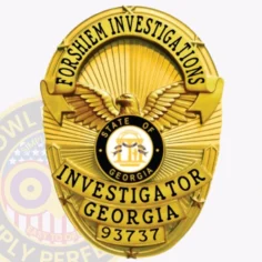 A detailed image of a custom metal badge in gold color with a safety pin attachment, highlighting "investigator georgia 93737. " this badge's refined design includes an eagle and decorative elements, showcasing its importance for private investigators.