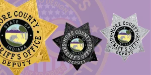 Three custom sheriff badges for the Shore County Sheriff's Office Deputy, showcasing different finishes: gold, black, and silver. Each badge features a detailed state emblem of Indiana at the center, surrounded by bold text. The image highlights options for designing, creating, building, and ordering personalized sheriff badges and deputy sheriff badges online.