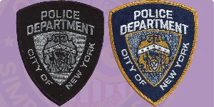 An image displaying two custom subdued patches: on the left, a black patch featuring detailed silver embroidery with 'Police Department City of New York,' and on the right, a navy blue patch with vibrant yellow lettering and similar design elements. This visual guide illustrates how to order custom subdued patches, showcasing their subtle yet authoritative appearance suitable for uniforms.