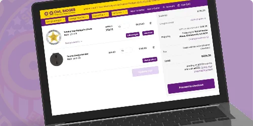 A laptop screen displaying the Owl Badges website showcasing Custom US Marshal Badges for design and ordering. The webpage features badge images, pricing, and customization options, helping users decide when to buy, design, and order professional US Marshal badges for official use or display purposes. The siteโs vibrant purple and yellow interface ensures a streamlined shopping experience
