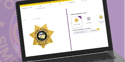A laptop screen displaying an online badge customization tool for sheriff and deputy badges. The interface shows a detailed gold star-shaped sheriff badge for 'Hope County Sheriff's Office,' featuring a central seal with intricate designs. To the right, options for selecting badge types, shapes, and personalization are clearly visible, allowing users to design, create, build, and order custom sheriff badges easily online. This image highlights where to buy personalized sheriff badges and deputy sheriff badges with accessible, user-friendly customization features.