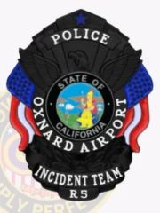 Alt Tag: A custom metal badge in silver with gold panels designed for law enforcement. The badge features a sleek black finish with a prominent eagle emblem at the top. It displays the title “POLICE” and has blue and red accents on either side. In the center, a circular seal represents the “STATE OF CALIFORNIA,” showcasing a colorful scene. Below the seal, the words “OXNARD AIRPORT INCIDENT TEAM” are clearly visible, along with the badge number “R5.” The badge's official and distinguished appearance makes it a striking symbol of authority.