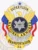 A decorative custom metal badge in silver color adorned with gold panels and a safety pin attachment. This badge includes an eagle motif with the word "SUPERVISOR" prominently displayed, surrounded by "NATIONAL ARMORED TRANSPORTATION." The colorful design blends red, white, and blue elements, enhancing its visual appeal and official representation.