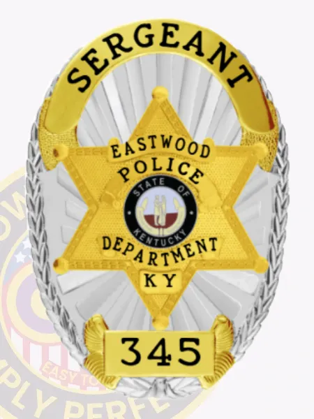 Detailed custom silver oval metal badge for Eastwood police sergeant with radiant silver sunray texture surrounding a central gold six-point star framing the colorful Kentucky seal, bold black text SERGEANT on a curved gold banner at the top, EASTWOOD POLICE DEPARTMENT inside the star, and numeric ID 345 on a gold plaque at the bottom; secured by safety pin.