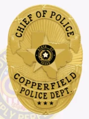 Custom gold metal police badge in an oval design for Copperfield chief, highlighting a central Texas map with a black circular "STATE OF TEXAS" emblem, black text "CHIEF OF POLICE" on top and "COPPERFIELD POLICE DEPT." underneath, featuring three stars at the bottom and attached via safety pin.