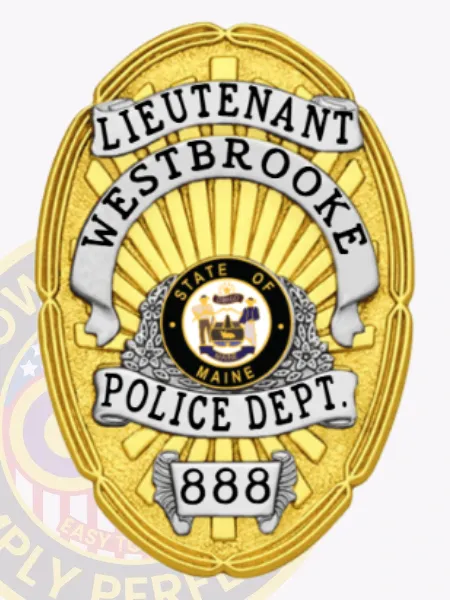 Gold oval custom metal badge designed for Westbrooke police lieutenant displaying a radiant gold background with white banners carrying the text LIEUTENANT, WESTBROOKE, POLICE DEPT., a central Maine state seal in black and gold, and the numeric ID 888 on a silver plaque near the bottom, attached with safety pin.