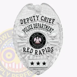 An elegant portrayal of a custom metal badge in silver, featuring "DEPUTY CHIEF" prominently displayed. The badge also includes "POLICE DEPARTMENT," the state emblem of Louisiana, and identifies as belonging to "RED RAPIDS." The safety pin attachment is highlighted, showcasing its practical use.