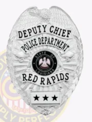 This image captures a polished custom metal badge in silver, showcasing "DEPUTY CHIEF" at the top along with "POLICE DEPARTMENT." The badge features the state emblem of Louisiana and identifies as part of "RED RAPIDS." The safety pin attachment is visible for secure attachment to uniforms.