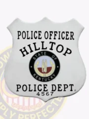 Detailed custom silver metal shield badge for Hilltop police officer with safety pin fastener, featuring POLICE OFFICER printed clearly at the top, HILLTOP curved beneath, a round State of Kentucky seal emblem in the center, and POLICE DEPT. 4567 in black text near the bottom.