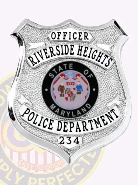 Detailed custom silver metal shield badge for Riverside Heights police officer with safety pin fastener, featuring OFFICER clearly printed on a small white banner at the top, RIVERSIDE HEIGHTS curved across the middle, a round State of Maryland seal emblem in the center, POLICE DEPARTMENT on a lower banner, and 234 near the base.