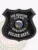 Clear Springs police Ice Rescue badge in a black shield metal design, showing white lettering "ICE RESCUE," "CLEAR SPRINGS," and "POLICE DEPT." surrounding a detailed Alaska state emblem, fastened by a safety pin on the back.