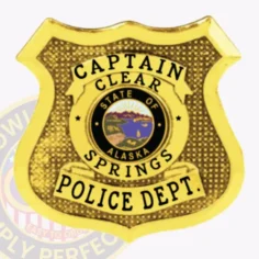 Custom-designed gold shield metal badge for clear springs police captain displaying clear black text on three curved banners and a detailed alaska state seal at the center, secured by a traditional safety pin attachment.