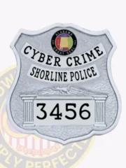 Silver shield-shaped custom metal badge for Shoreline Police cyber crime unit with a safety pin backing, featuring CYBER CRIME in uppercase black letters on a white arching strip, SHORELINE POLICE beneath it in smaller black text on white, and the ID number 3456 prominently displayed between two column designs, topped by the Alabama state seal emblem.