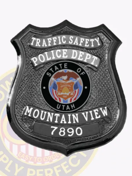 Detailed custom black metal shield badge for Mountain View police traffic safety unit with safety pin fastener, featuring TRAFFIC SAFETY boldly printed on a curved white banner at the top, POLICE DEPT. underneath, a round State of Utah seal emblem in the middle, and MOUNTAIN VIEW 7890 displayed clearly near the base.