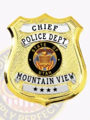 Gold shield-shaped custom metal badge for Mountain View Police chief with safety pin backing, displaying CHIEF in uppercase black font on a white arched panel at the top, POLICE DEPT. beneath it, the colorful State of Utah emblem in the center, and MOUNTAIN VIEW with four black stars on a white strip near the base.