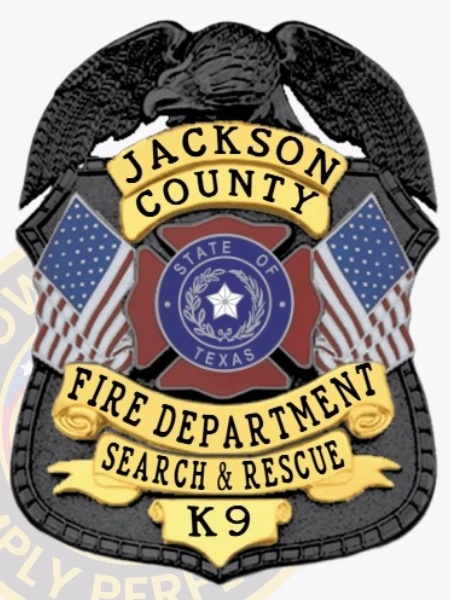 This eye-catching custom metal badge in black color has gold panels and a safety pin attachment for practical use. It displays "JACKSON COUNTY FIRE DEPARTMENT SEARCH & RESCUE K9" and features the Texas state emblem and flags, honoring the bravery of K9 units in fire service.