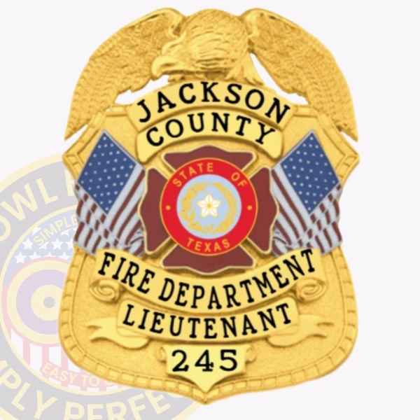 This elegant custom metal badge in a radiant gold color comes with a safety pin attachment for ease of use. It prominently features "JACKSON COUNTY FIRE DEPARTMENT LIEUTENANT 245," complemented by the state emblem of Texas and decorative flags.